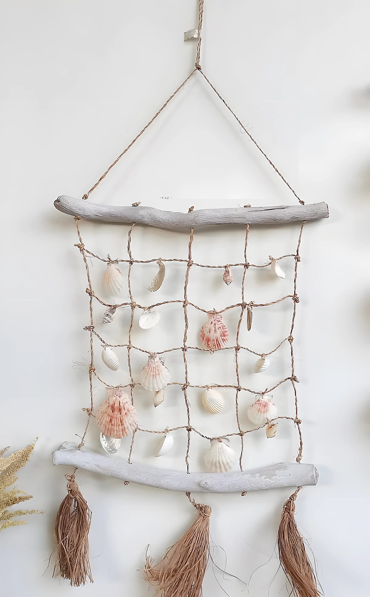 Moon-shaped shell dreamcatcher with pearl strands, tassels, and star accent; moderate craft difficulty.