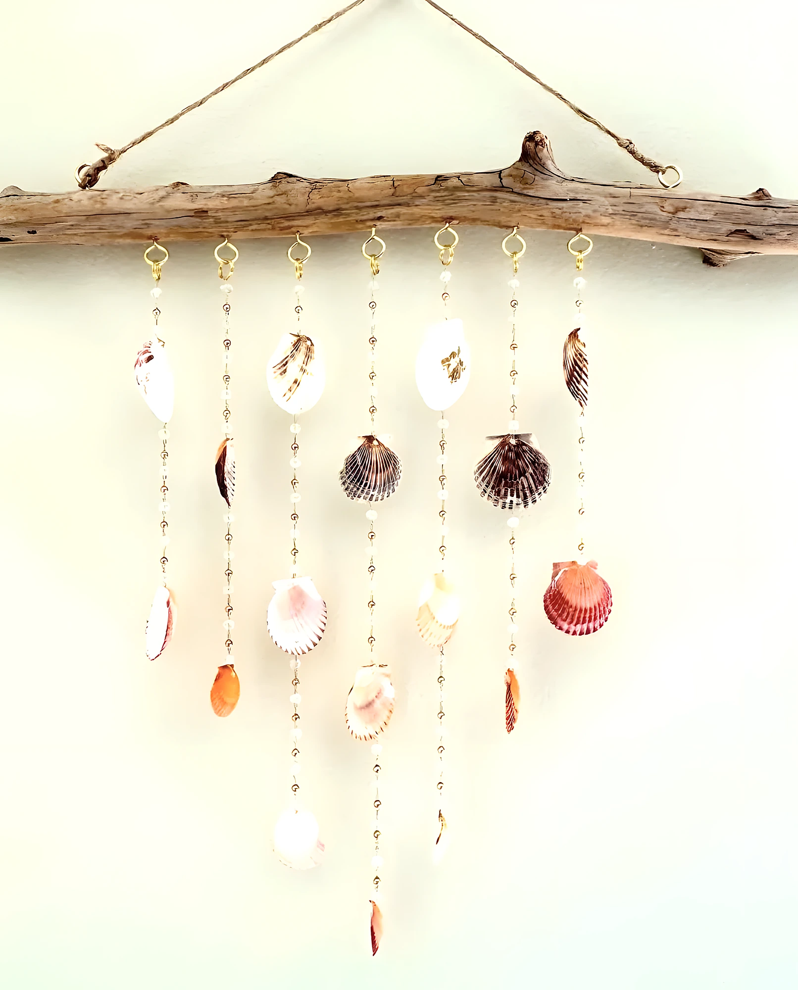 Fine chain shell wind chime with driftwood top and tiny dangling shells, advanced handmade seaside decor.