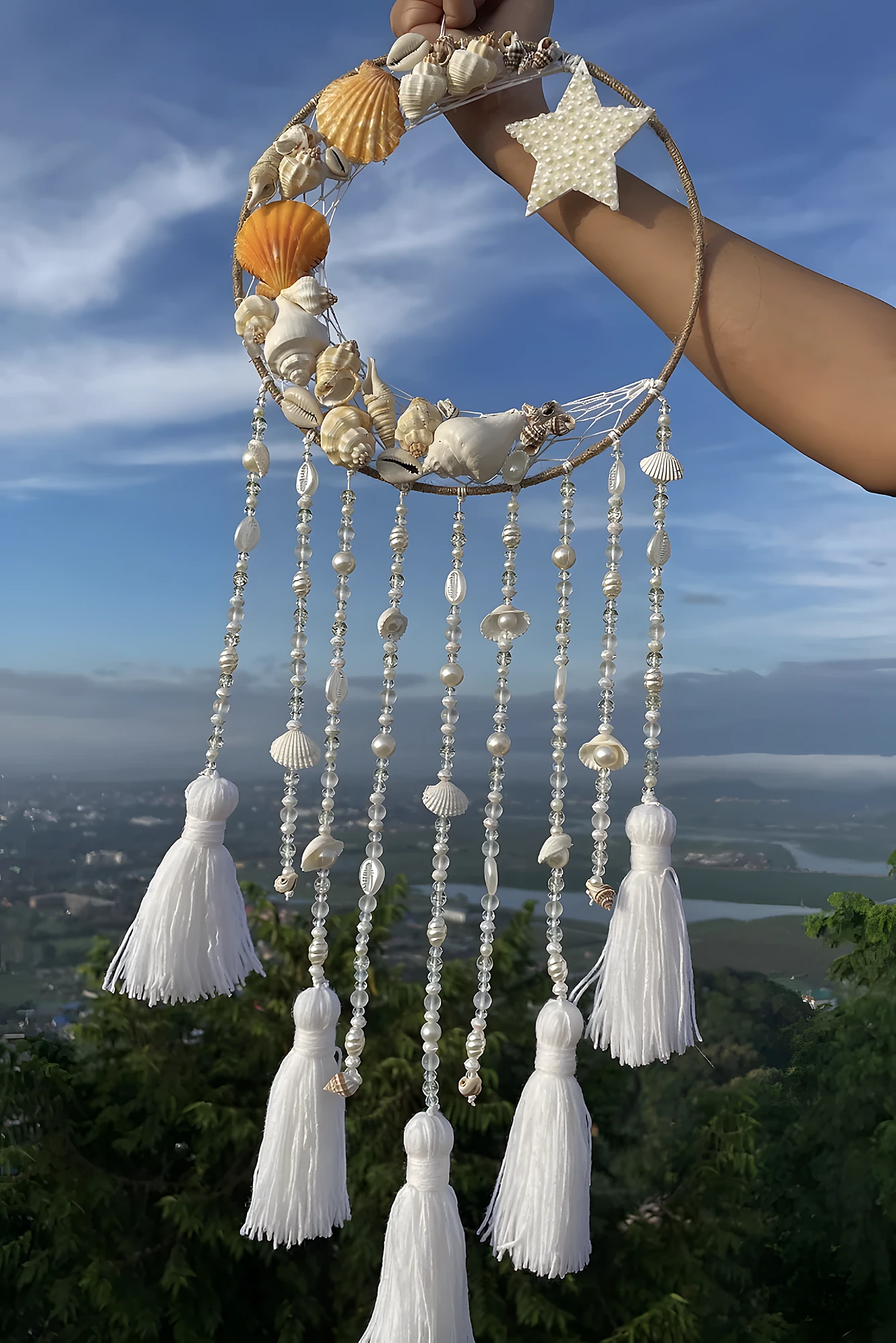 Beach-inspired wind chime with shell-covered hoop, bead strands, and tassels; intermediate difficulty.