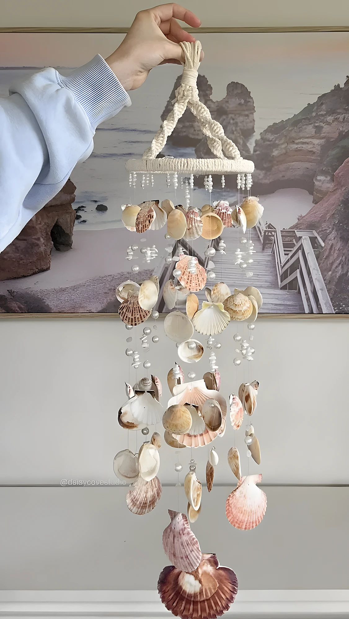 Handcrafted shell wind chime with braided cord, dangling beads, and mixed seashells; moderate difficulty.