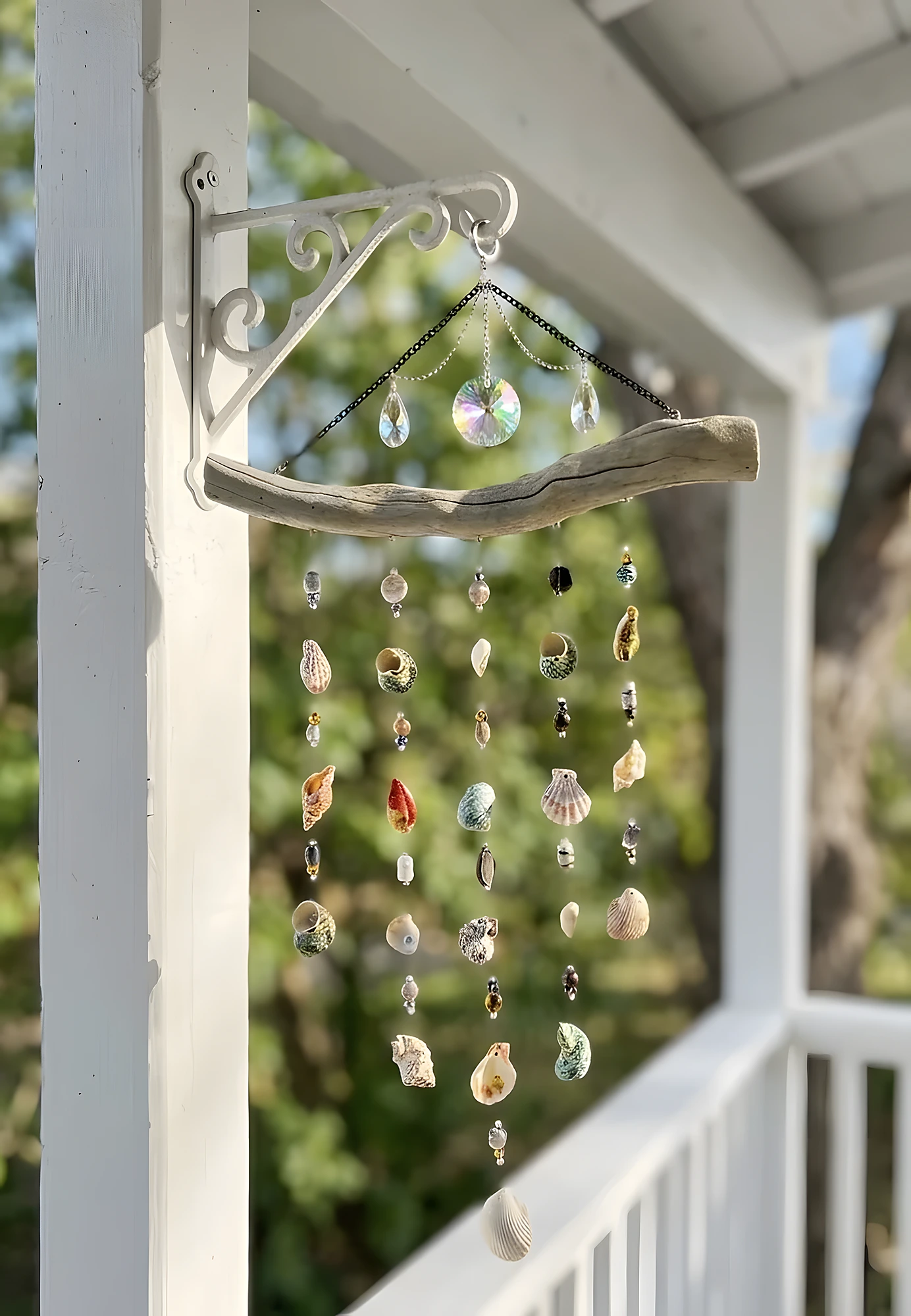 Driftwood branch wind chime with shell strands, clear beads, and crystal drops; beginner-friendly coastal wall decor.